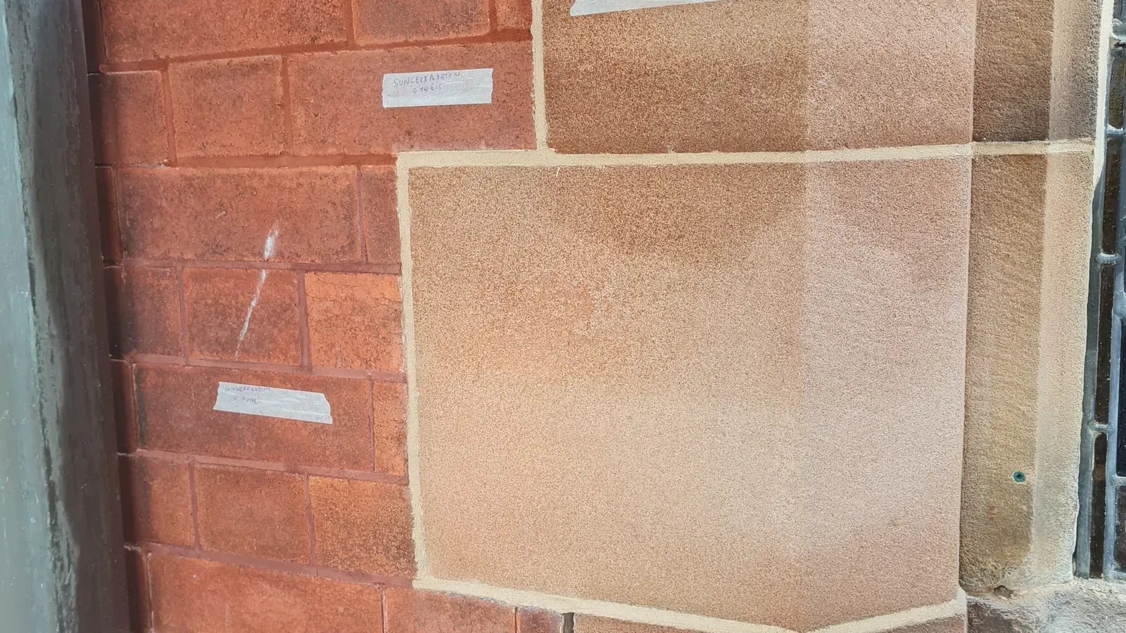 Close-up of red brickwork beside sandstone blocks, showing mortar joints and labelled sample areas.