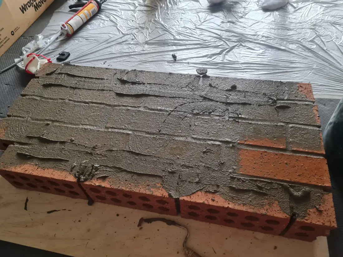 Mortar colour and finish being trialled across a small brick sample