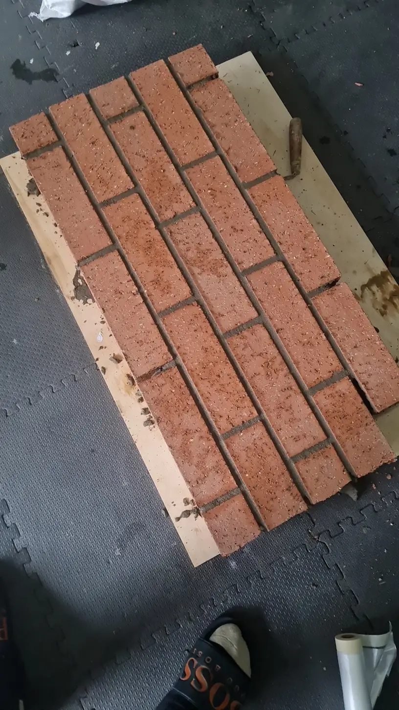 Finished brick sample panel with matched mortar and struck joints