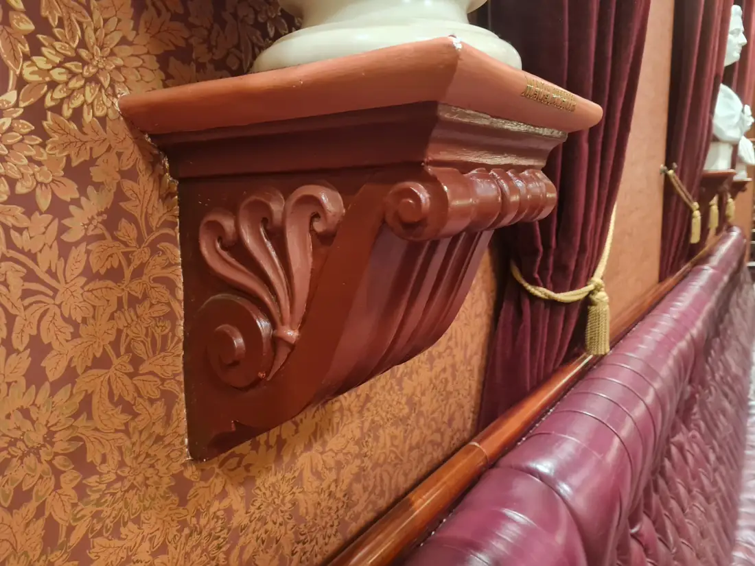 Close-up of a carved console bracket with acanthus scroll detail