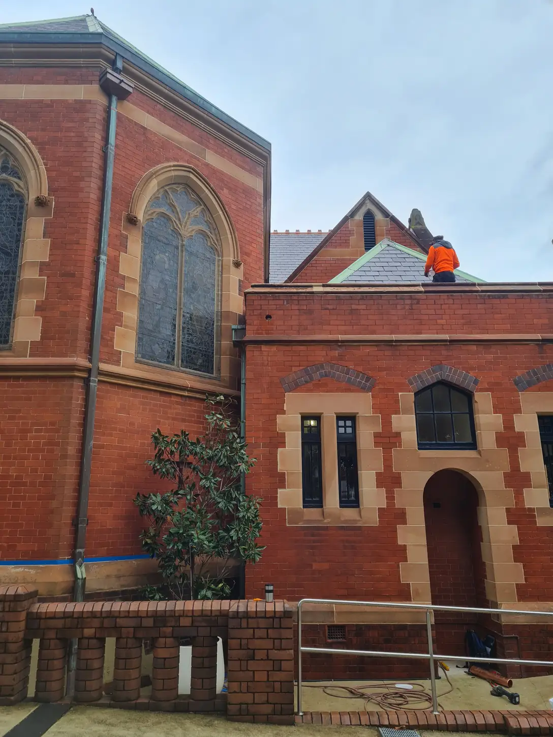 Heritage brick and sandstone building affected by rising damp and mould