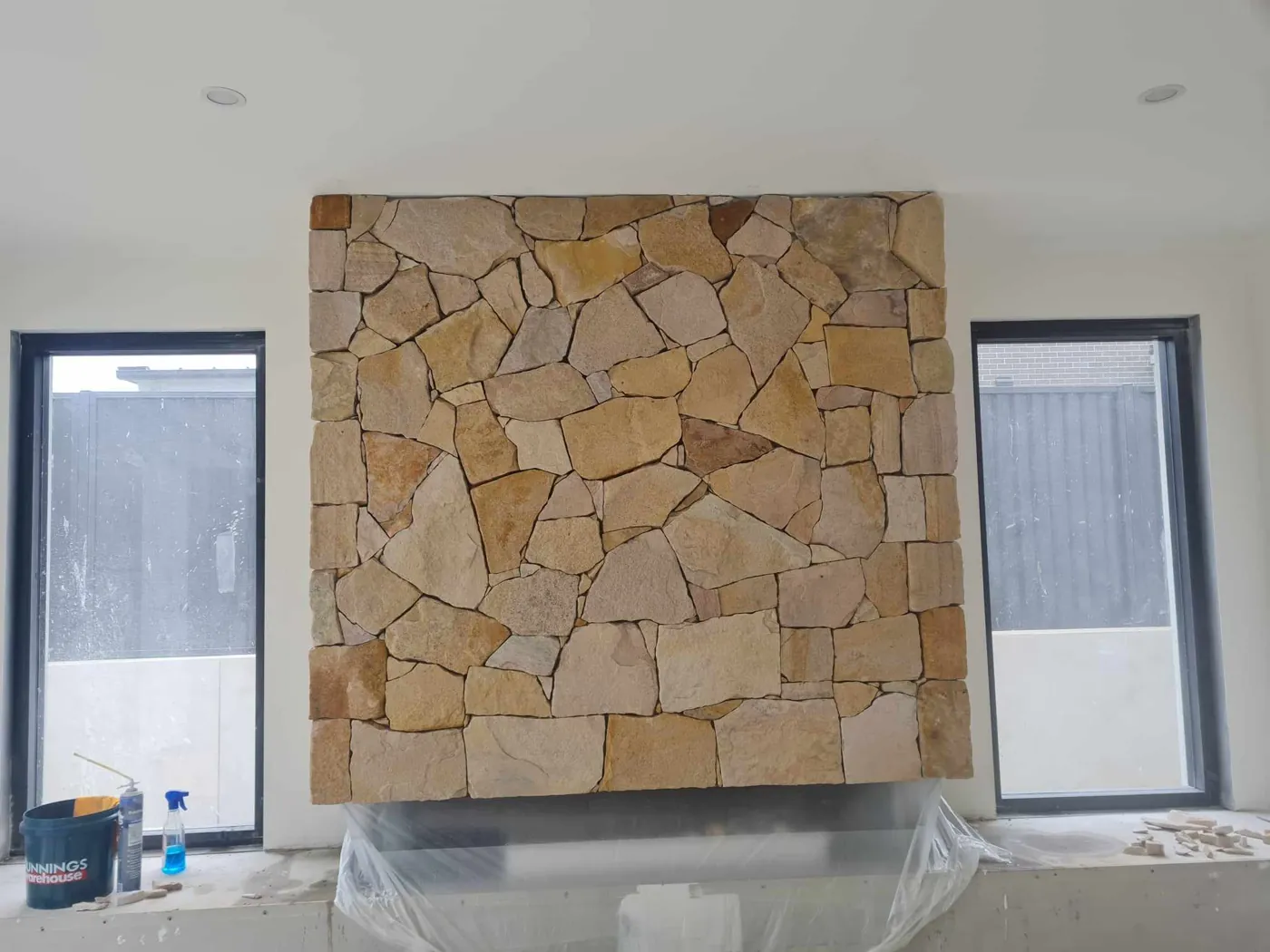 Finished sandstone cladding feature wall between two windows
