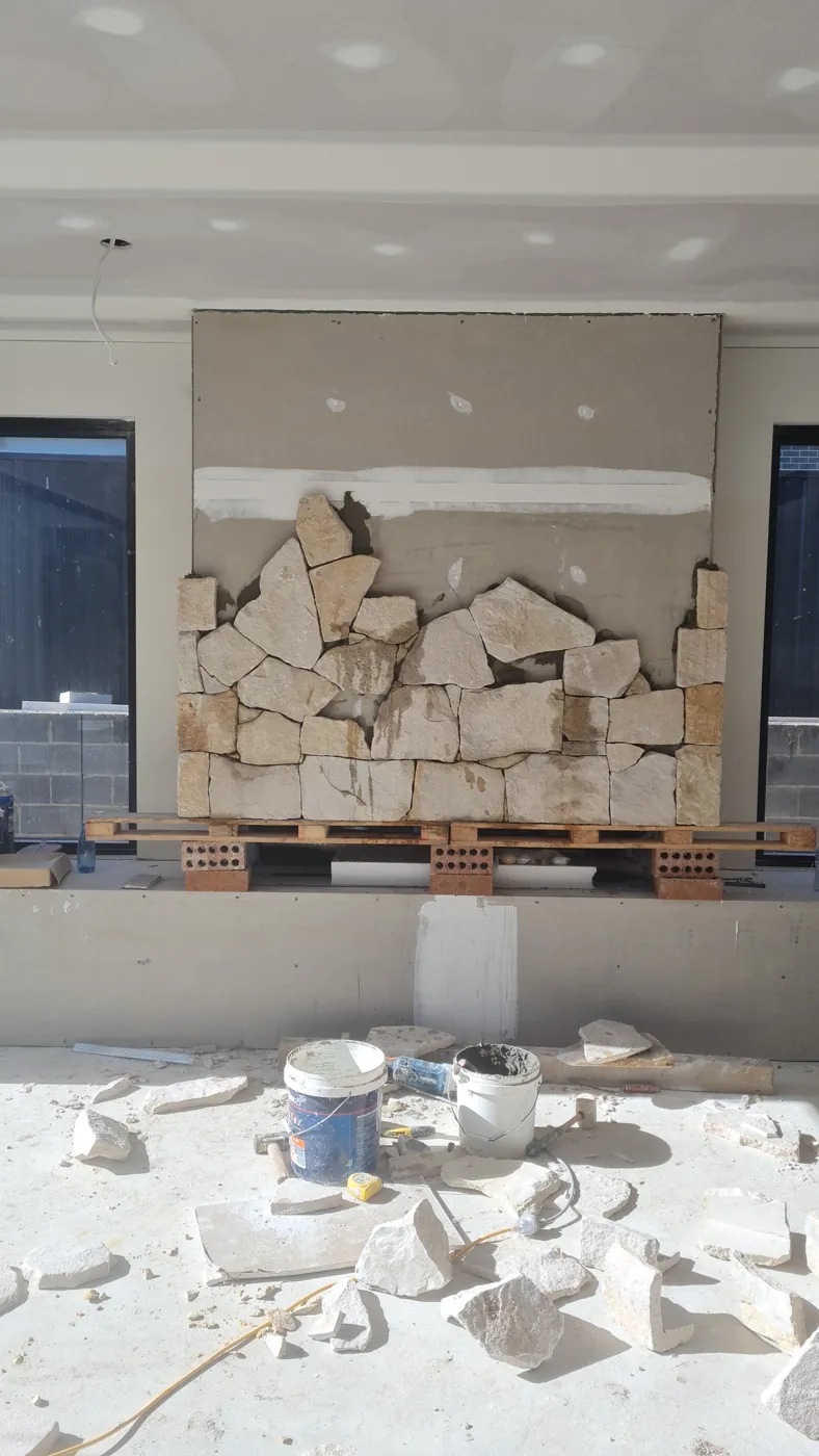 Sandstone cladding part-way through installation